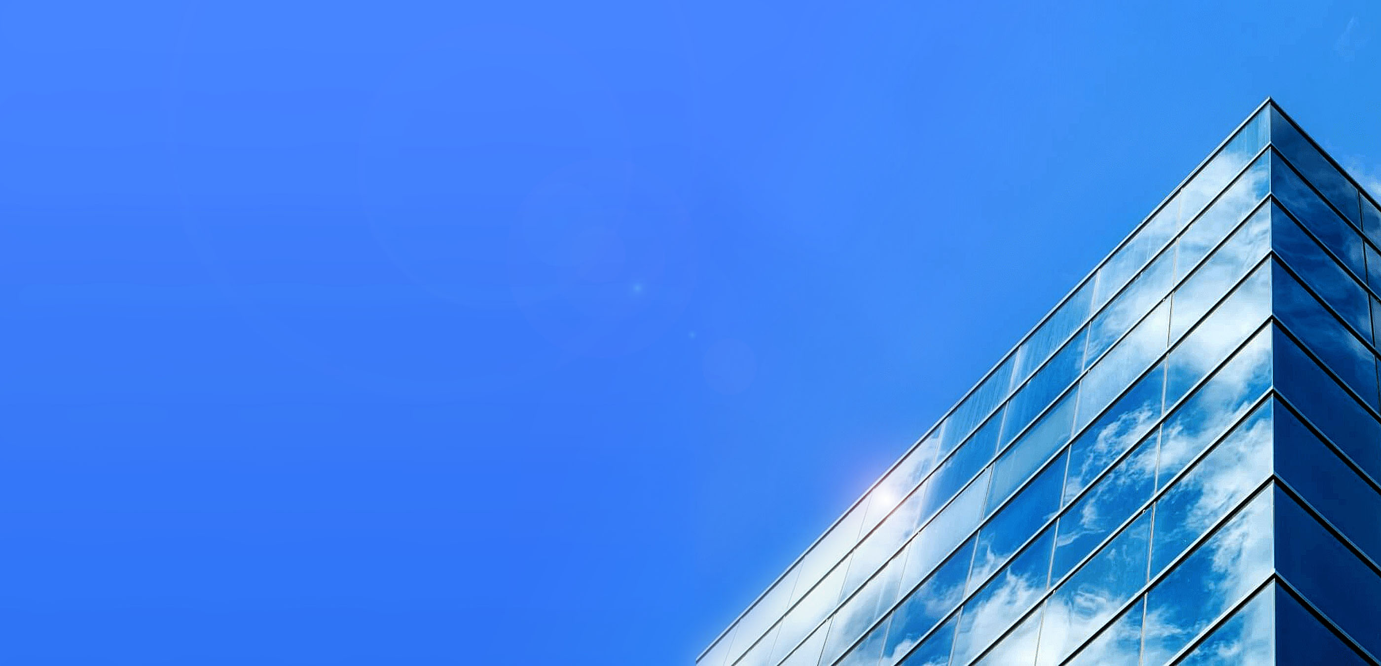 view of edge of a building with clouds on sky