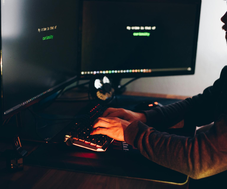 person working oncomputer with external monitors